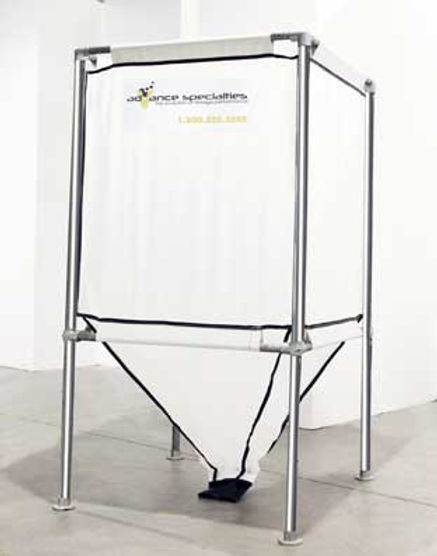A rectangular frame of metal pipes holds a rectangle silo made of white fabric. The lower 40% of the silo is a conical shape that tapers to a small black opening near the floor. 